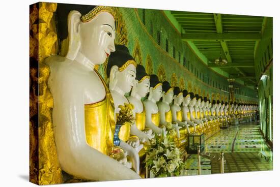 Myanmar. Mandalay. Sagaing Hill. Thirty Caves Temple. Row of Buddhas-Inger Hogstrom-Stretched Canvas