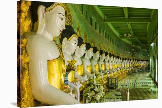 Myanmar. Mandalay. Sagaing Hill. Thirty Caves Temple. Row of Buddhas-Inger Hogstrom-Stretched Canvas