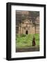 Myanmar, Mingun. a Young Monk Walking Beneath a Massive Temple Wall at Ruins of Mingun Pahtodawgyi-Brenda Tharp-Framed Photographic Print