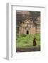 Myanmar, Mingun. a Young Monk Walking Beneath a Massive Temple Wall at Ruins of Mingun Pahtodawgyi-Brenda Tharp-Framed Photographic Print