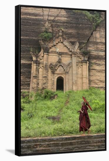 Myanmar, Mingun. a Young Monk Walking Beneath a Massive Temple Wall at Ruins of Mingun Pahtodawgyi-Brenda Tharp-Framed Stretched Canvas