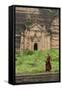 Myanmar, Mingun. a Young Monk Walking Beneath a Massive Temple Wall at Ruins of Mingun Pahtodawgyi-Brenda Tharp-Framed Stretched Canvas