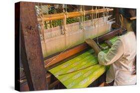 Myanmar. Shan State. Inle Lake. Woman weaving silk at a wooden loom.-Inger Hogstrom-Stretched Canvas