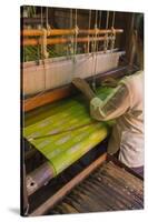 Myanmar. Shan State. Inle Lake. Woman weaving silk at a wooden loom.-Inger Hogstrom-Stretched Canvas