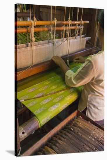 Myanmar. Shan State. Inle Lake. Woman weaving silk at a wooden loom.-Inger Hogstrom-Stretched Canvas