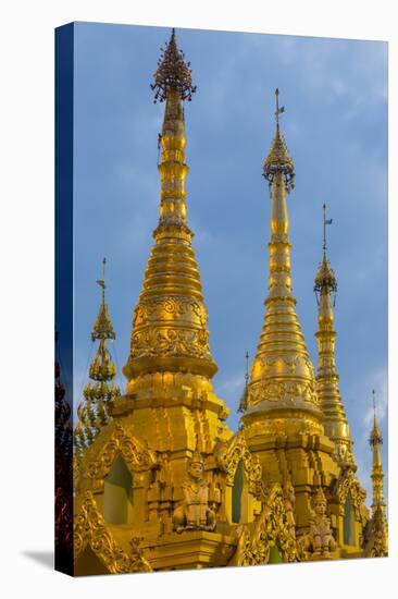 Myanmar. Yangon. Shwedagon Pagoda. Golden Spires Gleam at Twilight-Inger Hogstrom-Stretched Canvas