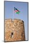 Namibia, Etosha National Park. Namibian flag flies over brick tower at park entrance.-Jaynes Gallery-Mounted Photographic Print