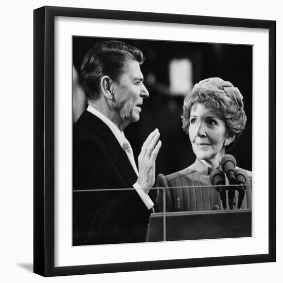 Nancy Reagan Proudly Watches as Her Husband Ronald Reagan Takes the Oath of Office-null-Framed Photographic Print