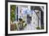 Narrow street, whitewashed buildings with blue paint work, flowers, Mykonos Town (Chora), Mykonos,-Eleanor Scriven-Framed Photographic Print