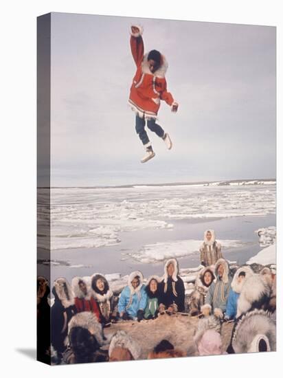 Native Alaskans Playing a Game of Nulukatuk, in Which Individals are Tossed into the Air-Ralph Crane-Stretched Canvas