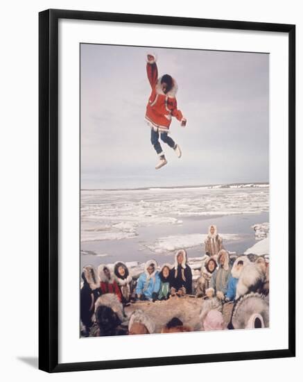 Native Alaskans Playing a Game of Nulukatuk, in Which Individals are Tossed into the Air-Ralph Crane-Framed Photographic Print
