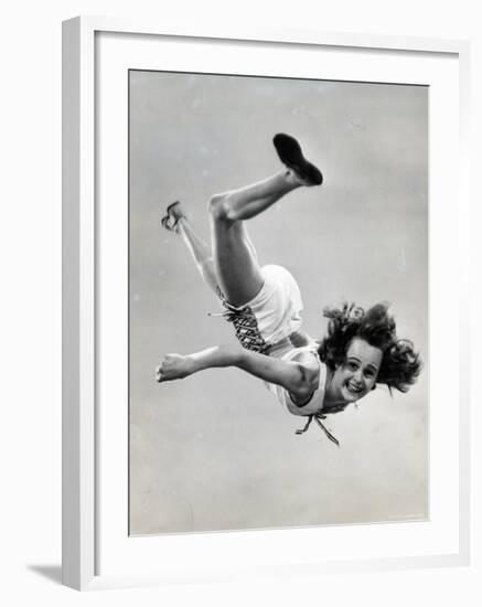 Natl. Women's Tumbling Champion, 15 Year Old, Bonnie Nebelong, in Mid Air with Legs Akimbo-Gjon Mili-Framed Photographic Print