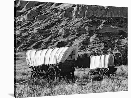 Nebraska, Scotts Bluff National Monument. Covered Wagons in Field-Dennis Flaherty-Stretched Canvas