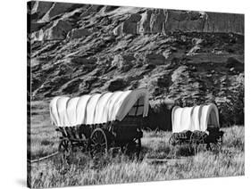 Nebraska, Scotts Bluff National Monument. Covered Wagons in Field-Dennis Flaherty-Stretched Canvas