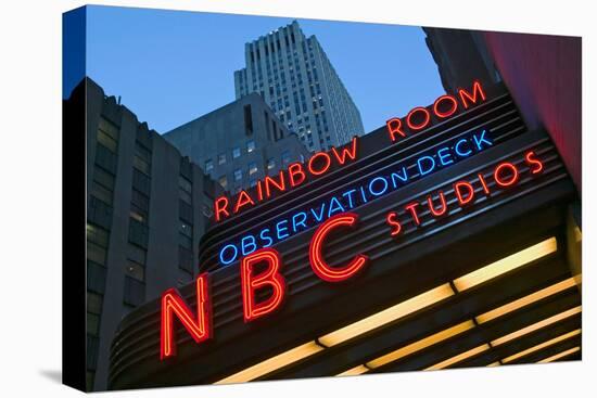 Neon lights of NBC Studios and Rainbow Room at Rockefeller Center, New York City, New York-null-Stretched Canvas