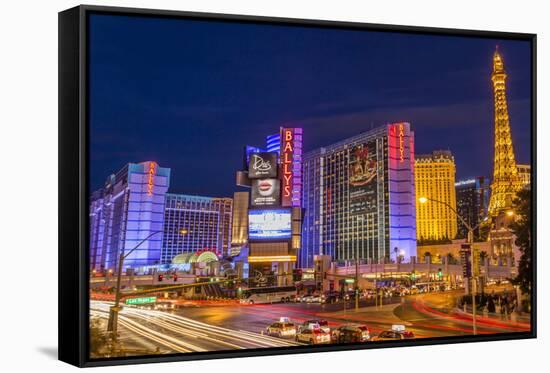 Neon Lights on Las Vegas Strip at Dusk with Car Headlights Leaving Streaks of Light-Eleanor Scriven-Framed Stretched Canvas