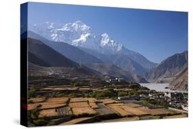 Nepal, Mustang, Kagbeni. the Soaring Peak of Nilgiri Behind the Village of Kagbeni.-Katie Garrod-Stretched Canvas