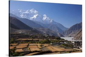 Nepal, Mustang, Kagbeni. the Soaring Peak of Nilgiri Behind the Village of Kagbeni.-Katie Garrod-Stretched Canvas