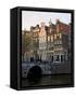 Netherlands, Amsterdam. Traditional houses along the canals and bridge crossing.-Julie Eggers-Framed Stretched Canvas