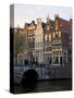 Netherlands, Amsterdam. Traditional houses along the canals and bridge crossing.-Julie Eggers-Stretched Canvas