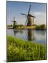 Netherlands, Kinderdijk, Windmills with evening light along the canals.-Terry Eggers-Mounted Photographic Print