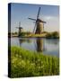 Netherlands, Kinderdijk, Windmills with evening light along the canals.-Terry Eggers-Stretched Canvas