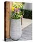 Netherlands, Lisse. Tall flower pot with yellow tulips and narcissus.-Julie Eggers-Stretched Canvas