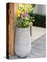 Netherlands, Lisse. Tall flower pot with yellow tulips and narcissus.-Julie Eggers-Stretched Canvas