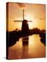 Netherlands, Nord Holland, Windmill along canal-Terry Eggers-Stretched Canvas