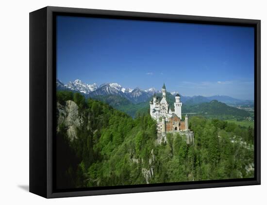 Neuschwanstein Castle on a Wooded Hill with Mountains in the Background, in Bavaria, Germany-null-Framed Stretched Canvas