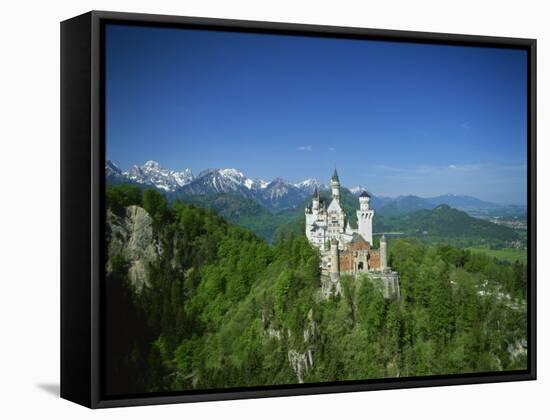 Neuschwanstein Castle on a Wooded Hill with Mountains in the Background, in Bavaria, Germany-null-Framed Stretched Canvas