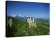 Neuschwanstein Castle on a Wooded Hill with Mountains in the Background, in Bavaria, Germany-null-Stretched Canvas