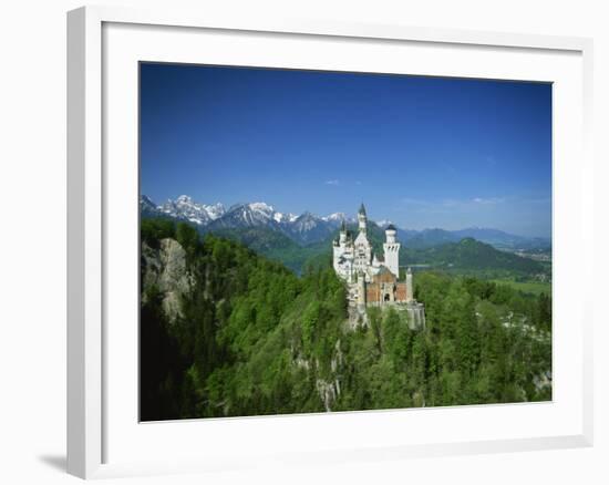 Neuschwanstein Castle on a Wooded Hill with Mountains in the Background, in Bavaria, Germany-null-Framed Photographic Print