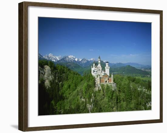 Neuschwanstein Castle on a Wooded Hill with Mountains in the Background, in Bavaria, Germany-null-Framed Photographic Print