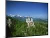Neuschwanstein Castle on a Wooded Hill with Mountains in the Background, in Bavaria, Germany-null-Mounted Photographic Print