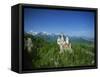 Neuschwanstein Castle on a Wooded Hill with Mountains in the Background, in Bavaria, Germany-null-Framed Stretched Canvas