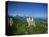 Neuschwanstein Castle on a Wooded Hill with Mountains in the Background, in Bavaria, Germany-null-Stretched Canvas