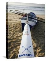 New South Wales, Sydney, A Surfboat Sits on Beach at Bondi in Sydney's Eastern Beaches, Australia-Andrew Watson-Stretched Canvas