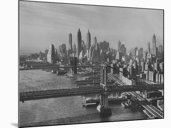 New York City Behind the Brooklyn and Manhattan Bridges That are Hovering over the East River-Dmitri Kessel-Mounted Photographic Print