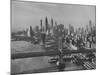 New York City Behind the Brooklyn and Manhattan Bridges That are Hovering over the East River-Dmitri Kessel-Mounted Photographic Print