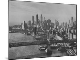 New York City Behind the Brooklyn and Manhattan Bridges That are Hovering over the East River-Dmitri Kessel-Mounted Photographic Print