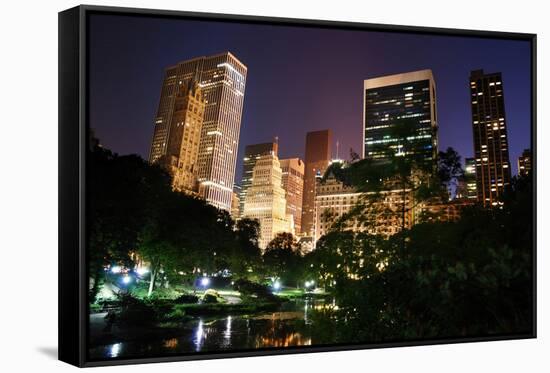 New York City Central Park at Night with Manhattan Skyscrapers Lit with Light.-Songquan Deng-Framed Stretched Canvas
