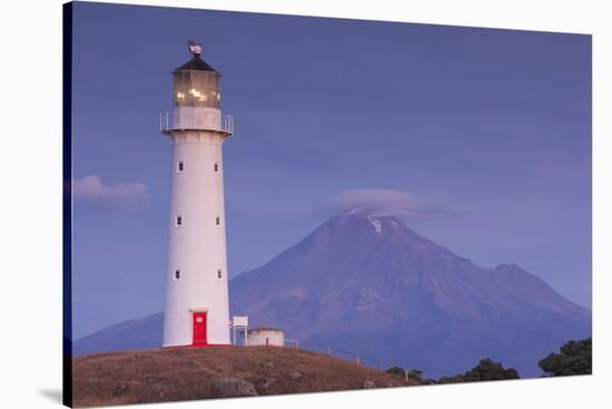 New Zealand, North Island, Pungarehu. Cape Egmont Lighthouse and Mt. Taranaki-Walter Bibikow-Stretched Canvas