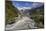 New Zealand, South Island, Fox Glacier Village, Fox Glacier hikers along Fox River-Walter Bibikow-Mounted Photographic Print