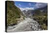 New Zealand, South Island, Fox Glacier Village, Fox Glacier hikers along Fox River-Walter Bibikow-Stretched Canvas