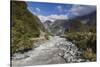 New Zealand, South Island, Fox Glacier Village, Fox Glacier hikers along Fox River-Walter Bibikow-Stretched Canvas