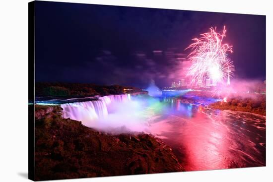 Niagara Falls Lit at Night by Colorful Lights with Fireworks-Songquan Deng-Stretched Canvas