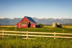 Summer Sunset with an Old Barn and a Rye Field in Rural Montana with Rocky Mountains in the Backgro-Nick Fox-Laminated Photographic Print