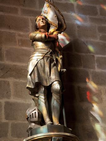 Statue of St. Joan of Arc with Coloured Light from Stained Glass, Church of Notre Dame, Vitre, Brit