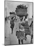 Nigerian Women with Babies Strapped to Their Backs Carrying Large Baskets on Their Heads-Alfred Eisenstaedt-Mounted Photographic Print